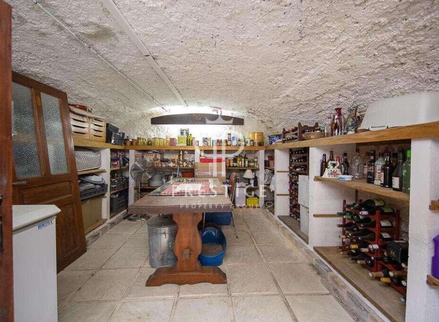Discover the charm of this unique property! This space features a rustic wine cellar, perfect for storing and showcasing your collection.