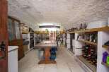 Discover the charm of this unique property! This space features a rustic wine cellar, perfect for storing and showcasing your collection.