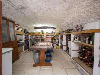 Discover the charm of this unique property! This space features a rustic wine cellar, perfect for storing and showcasing your collection.