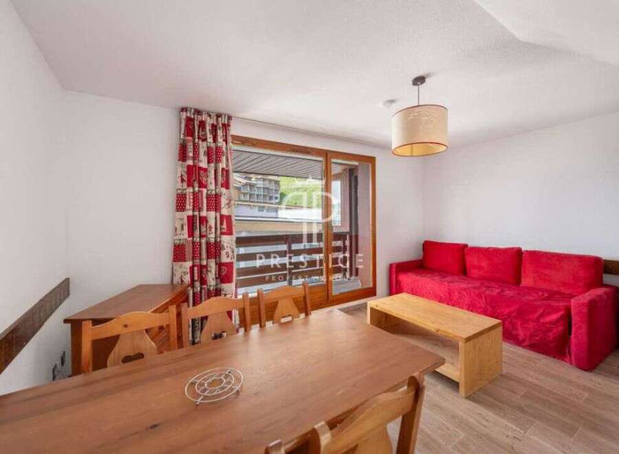 Discover a cozy living space with a vibrant red sofa, perfect for relaxation.