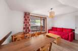 Discover a cozy living space with a vibrant red sofa, perfect for relaxation.