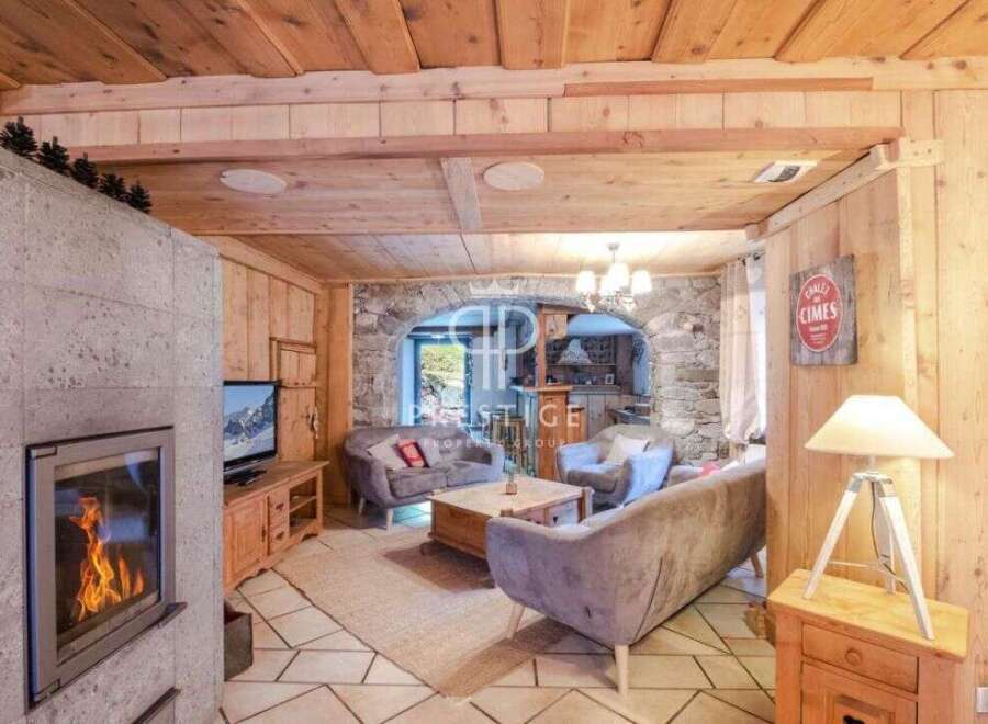 Experience the charm of this cozy chalet, featuring a warm fireplace and inviting wooden interiors.