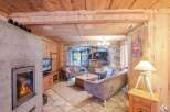 Experience the charm of this cozy chalet, featuring a warm fireplace and inviting wooden interiors.