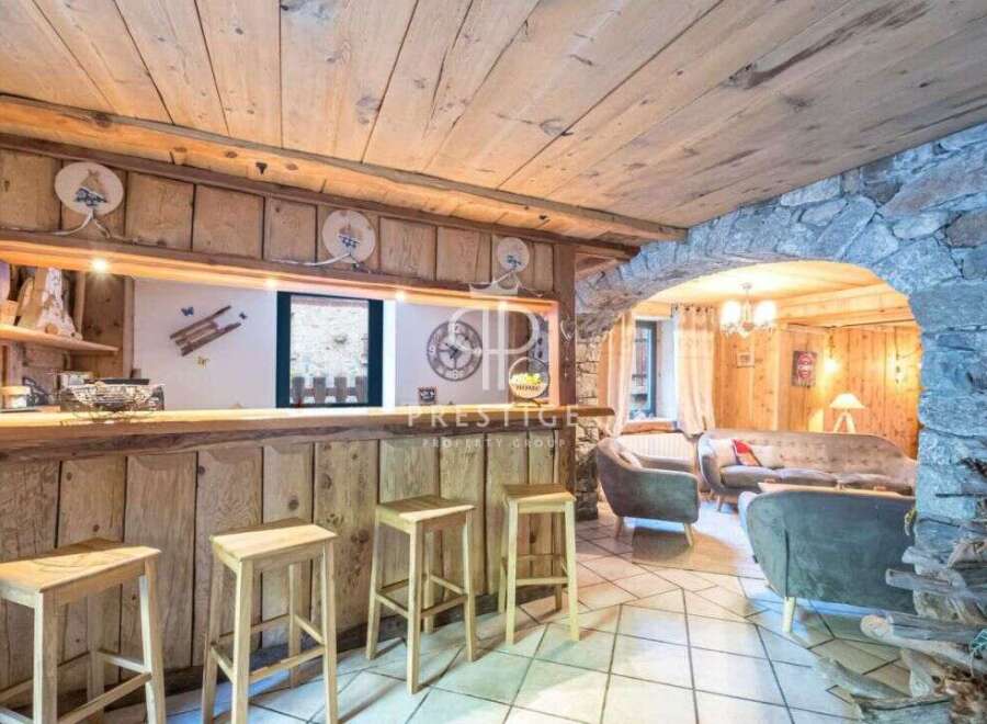 Discover rustic charm in this stunning property, featuring a cozy bar area perfect for entertaining.
