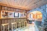 Discover rustic charm in this stunning property, featuring a cozy bar area perfect for entertaining.