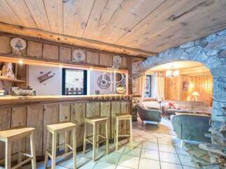 Discover rustic charm in this stunning property, featuring a cozy bar area perfect for entertaining.
