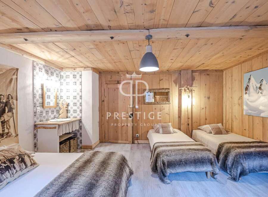 Experience rustic charm in this cozy bedroom, featuring warm wooden walls and ceilings.