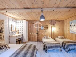 Experience rustic charm in this cozy bedroom, featuring warm wooden walls and ceilings.