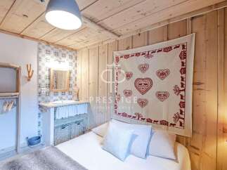Cozy bedroom with rustic wooden walls and ceiling.