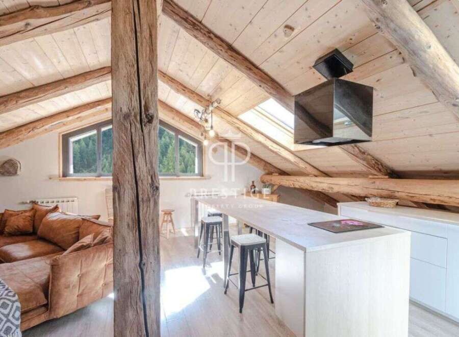 Discover the charm of this stunning property, featuring a unique architectural design with exposed wooden beams and a cozy, inviting atmosphere.