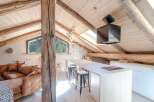 Discover the charm of this stunning property, featuring a unique architectural design with exposed wooden beams and a cozy, inviting atmosphere.
