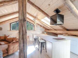 Discover the charm of this stunning property, featuring a unique architectural design with exposed wooden beams and a cozy, inviting atmosphere.