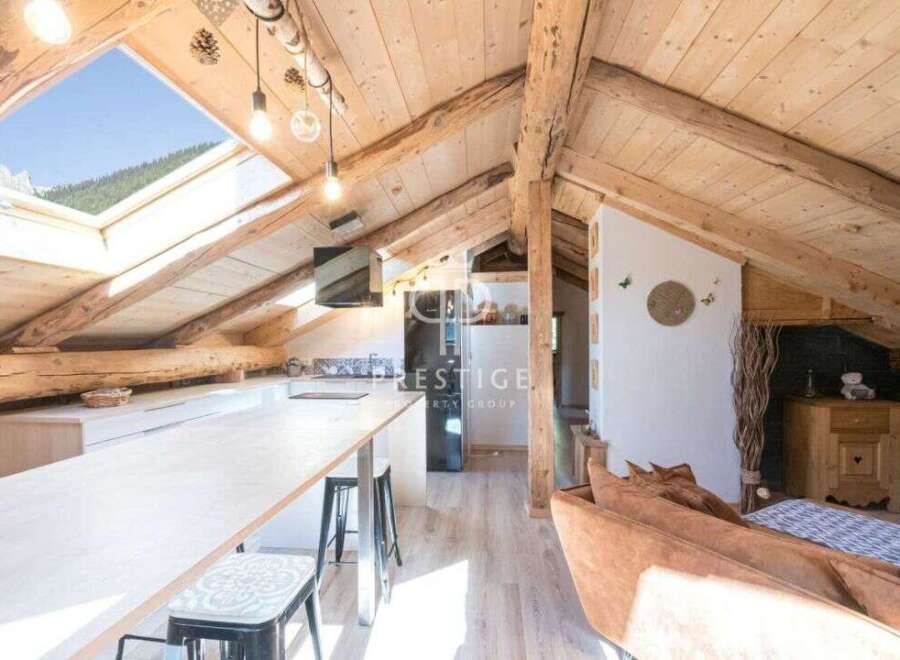 Discover the charm of this stunning property, featuring a unique attic design with exposed wooden beams.