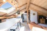 Discover the charm of this stunning property, featuring a unique attic design with exposed wooden beams.