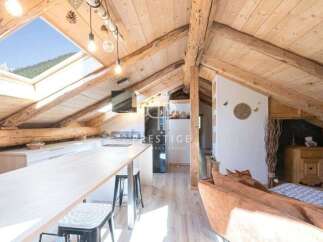 Discover the charm of this stunning property, featuring a unique attic design with exposed wooden beams.