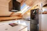 Discover this stunning property featuring a modern kitchen with sleek black appliances and a unique skylight.