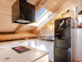 Discover this stunning property featuring a modern kitchen with sleek black appliances and a unique skylight.