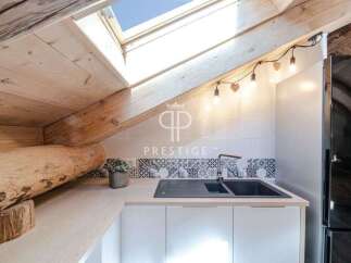 Discover the charm of this unique property, featuring a cozy kitchen with a skylight and wooden accents.