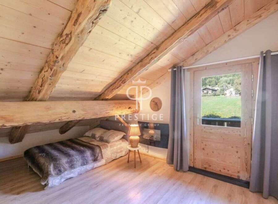 Discover the charm of this cozy bedroom with its rustic wooden beams and inviting ambiance.
