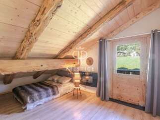 Discover the charm of this cozy bedroom with its rustic wooden beams and inviting ambiance.