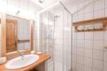 Discover a stylish bathroom with a modern shower and elegant wooden accents.