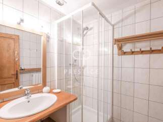 Discover a stylish bathroom with a modern shower and elegant wooden accents.
