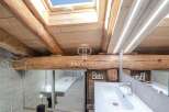 Discover the charm of this property, featuring a unique wooden beam ceiling and a skylight that floods the space with natural light.
