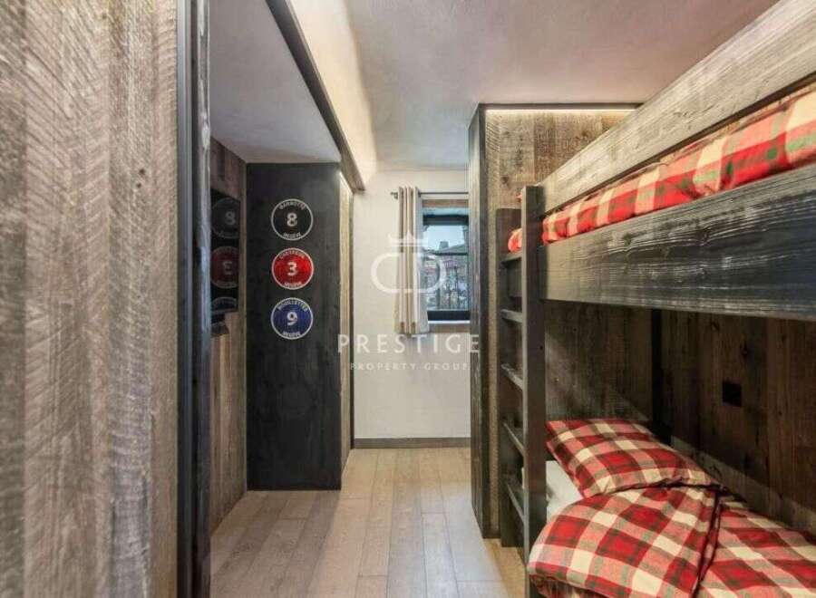 Discover a cozy retreat with this charming bunk bed setup.