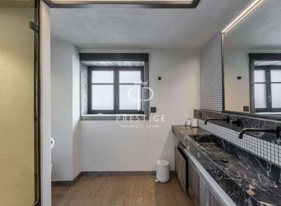 Discover luxury living at its finest! This stunning property boasts a modern bathroom design with sleek black marble countertops and stylish fixtures.