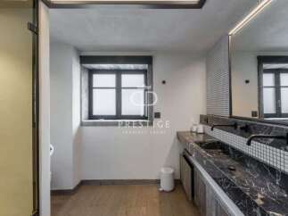 Discover luxury living at its finest! This stunning property boasts a modern bathroom design with sleek black marble countertops and stylish fixtures.