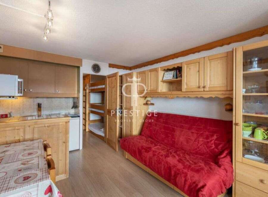 Discover this charming property featuring a cozy living space with a comfortable red sofa.