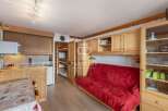 Discover this charming property featuring a cozy living space with a comfortable red sofa.