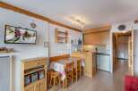 Cozy ski chalet with a charming dining area and a well-equipped kitchen.