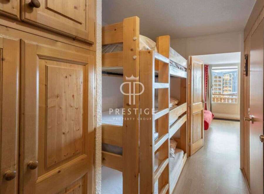 Discover a cozy bedroom featuring charming wooden bunk beds, perfect for accommodating guests.