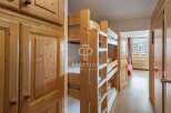 Discover a cozy bedroom featuring charming wooden bunk beds, perfect for accommodating guests.