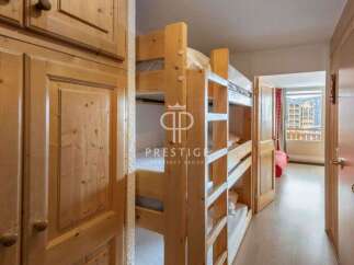 Discover a cozy bedroom featuring charming wooden bunk beds, perfect for accommodating guests.