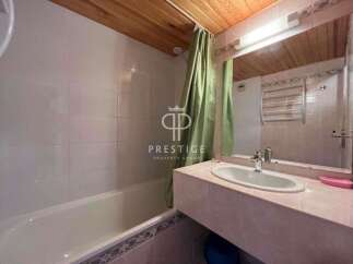 This bathroom features a sleek design with a modern sink and a spacious bathtub.