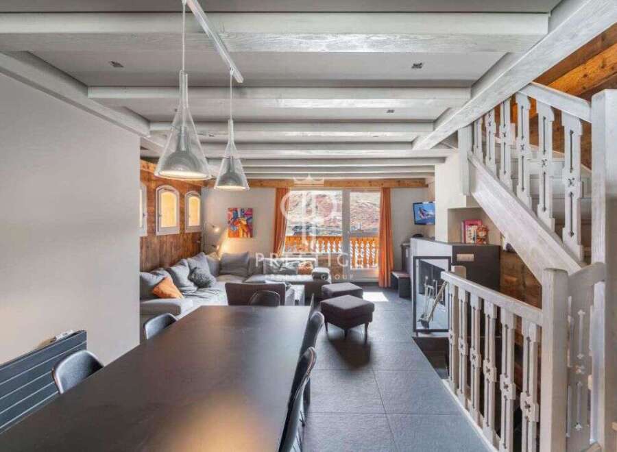 Discover the charm of this stunning property, featuring a cozy living area with a comfortable sofa and a dining table perfect for gatherings.