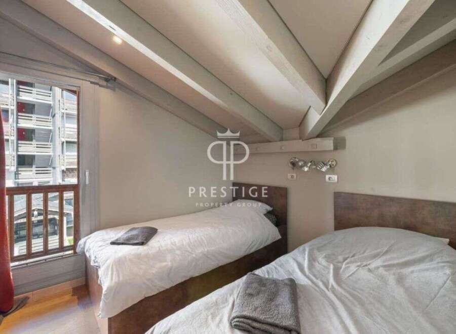 Discover a cozy bedroom with a unique sloped ceiling design.
