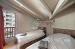 Discover a cozy bedroom with a unique sloped ceiling design.