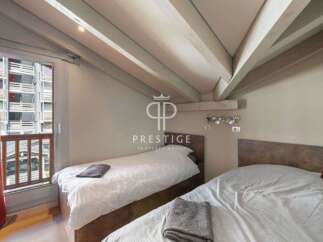 Discover a cozy bedroom with a unique sloped ceiling design.