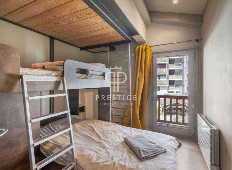 Discover a cozy bedroom with a unique bunk bed setup, perfect for maximizing space.