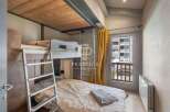 Discover a cozy bedroom with a unique bunk bed setup, perfect for maximizing space.