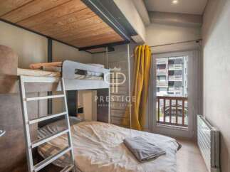 Discover a cozy bedroom with a unique bunk bed setup, perfect for maximizing space.