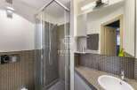 Discover this modern bathroom featuring a sleek glass shower enclosure.