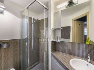 Discover this modern bathroom featuring a sleek glass shower enclosure.