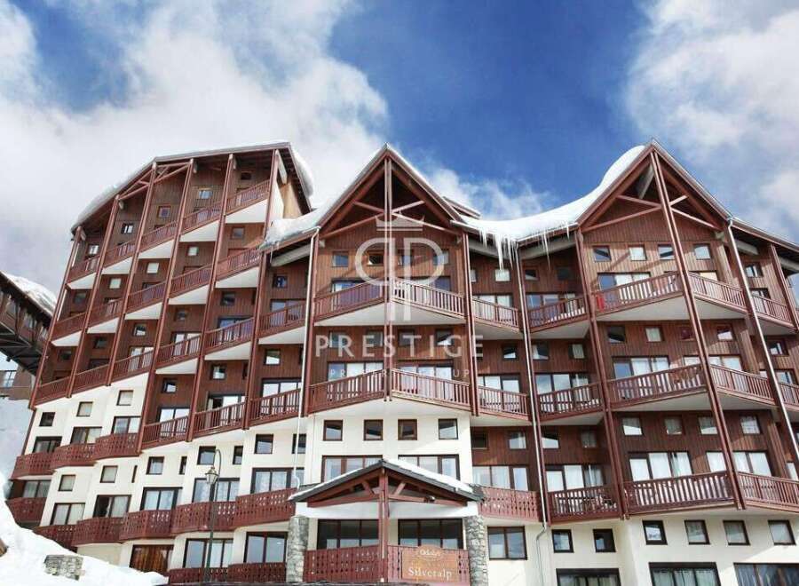 Discover the charm of this stunning property, featuring a unique architectural design with wooden accents and balconies.