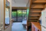 Discover a charming property with a unique layout, featuring a cozy living space and a convenient staircase.