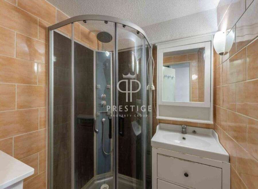 Discover a modern bathroom with a sleek shower enclosure.