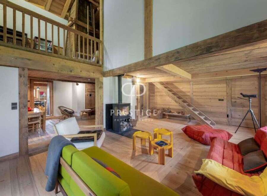 Discover rustic charm in this stunning property, featuring exposed wooden beams and a cozy fireplace.